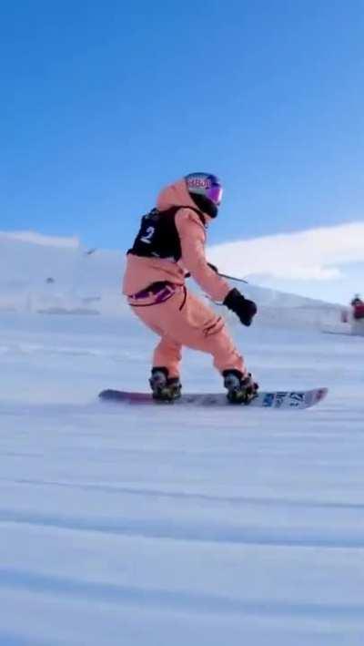 Snowboarding competition - camera operator maintains superb framing, tracking, composition while performing the same jumps as the competitor