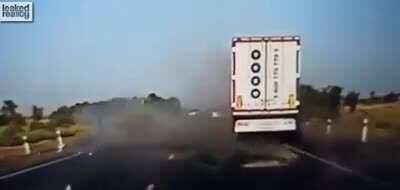 Passing car freaks out oncoming car into panic braking and losing control into truck.