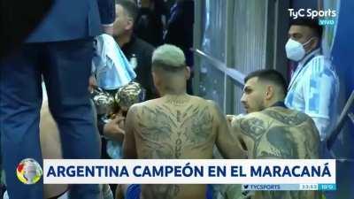 Messi, Neymar and Paredes, sitting on the corridor stairs after the celebrations, talking and laughing.