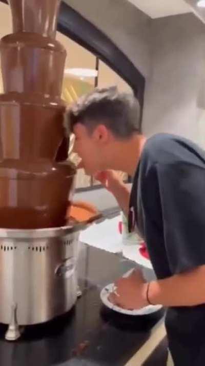 Main character contaminants a chocolate fountain for a video