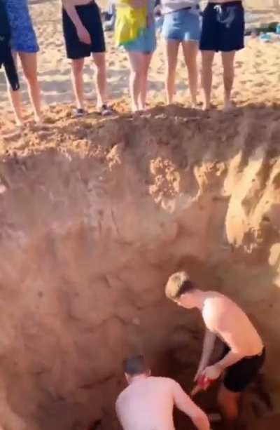 Boys see sand, boys dig hole