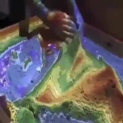 This Augmented reality sandbox allows you to interact with topographic maps by projecting them in 3D.