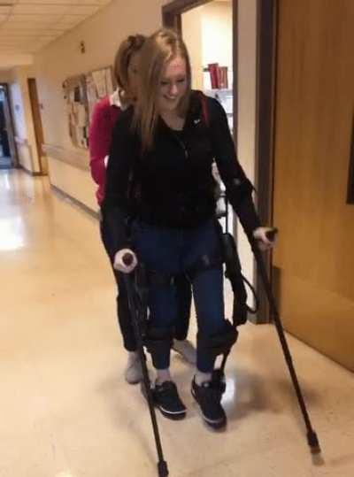 Girl with an exoskeleton walking for the very first time.