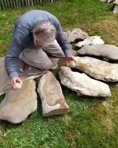 Archaeologist Dr. Jean-Loup Ringot specializes in prehistoric music, here he demonstrates a Lithophone.