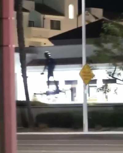 Man hover boarding/gliding down a street