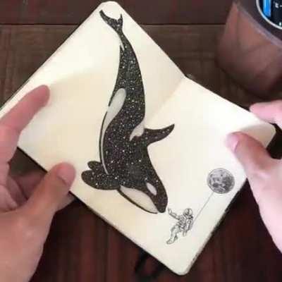 An artist showing off their sketchbook