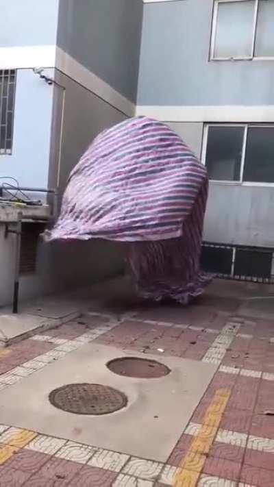 a blanket dancing in the wind