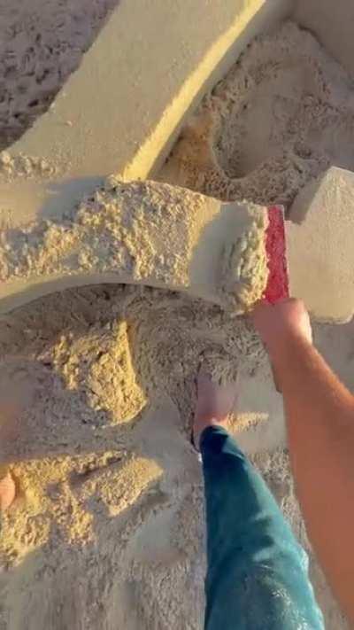 This sand lettering being smoothed out