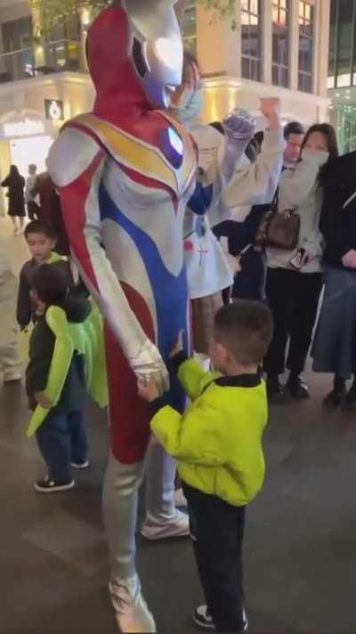 Ultra man breaks character after kid presses his button