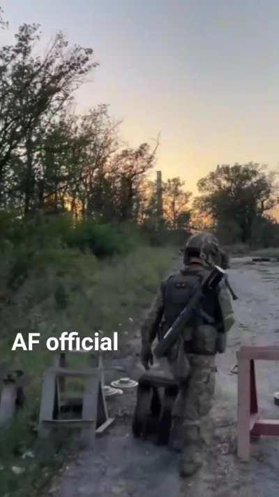 Ukrainian infantry march near the front, carrying light anti-tank weapons.