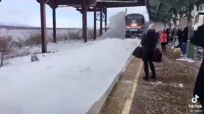 A train through a high blanket of snow