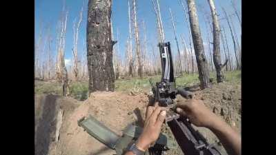 Colombian soldier defending his position using a machine gun survives an FPV drone attack. Kharkiv Oblast. Published on June 3, 2024.