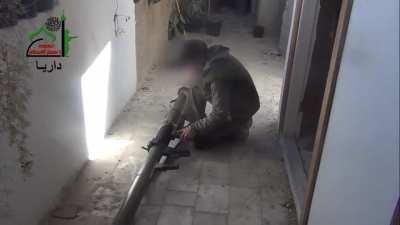 Miqdad bin Amir Brigade fighter observes and engages a Syrian Army T-72 with an M79 &quot;Osa&quot; launcher - Daraya - 3/2/2013