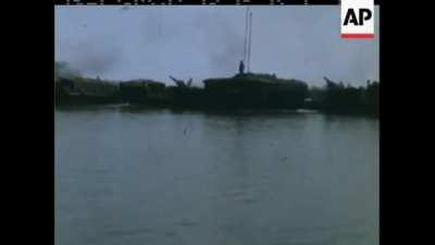 US Army riverine battery equipped with 105mm M102 howitzers on barges provides fire support in Vietnam in early 1970