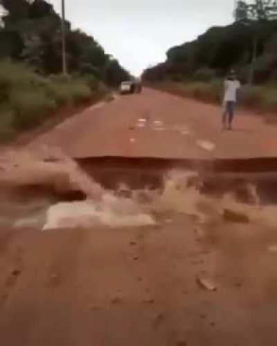 Road severed by powerful surge