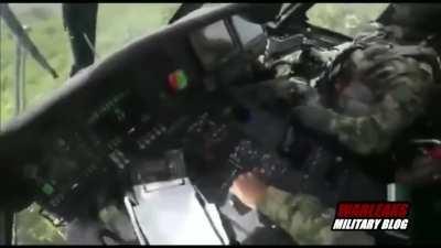 Colombian Black Hawk pilot takes enemy rifle round through the windshield while mid-air.