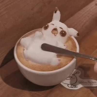 This latte foam art of trying to &quot;wake up&quot; Pikachu