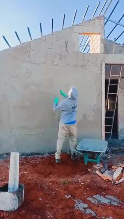 This guy throwing cement onto a wall.