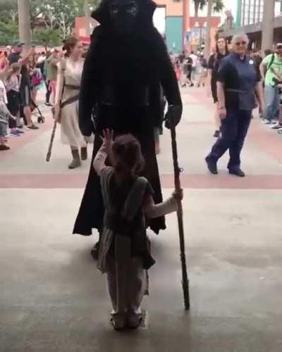 This kid stood still as the parade of Dark Sith with clone troopers passes.