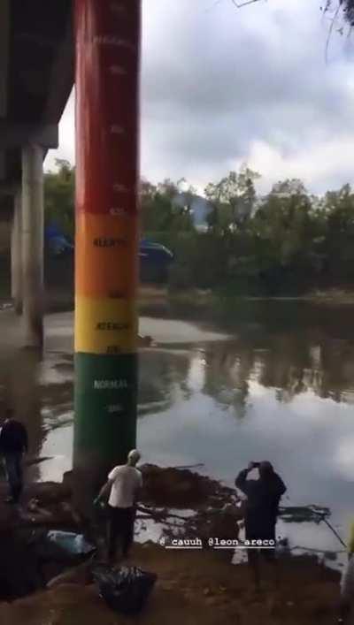 Helicopter flying under a small bridge