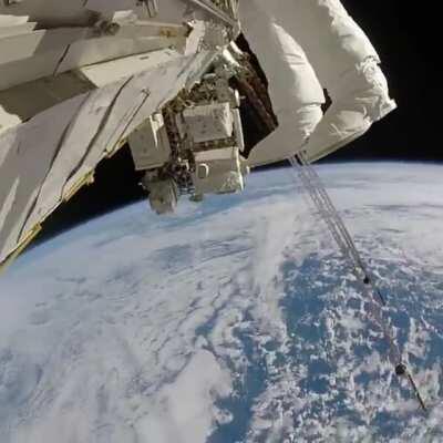 Astronaut's stunning view of Earth during a spacewalk on the ISS.