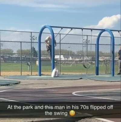 Old man does a flip while getting off the swings