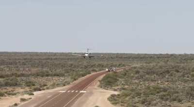 The Royal Flying Doctor, with an airborne police escort landing on an Outback highway. No cost to any patient, Australian or visitor, ever.