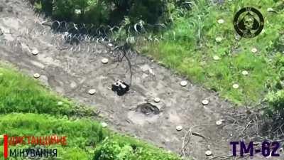 Mining of the area with TM-62 anti-tank mines using a remote-controlled robot by soldiers of 28 OBMr.