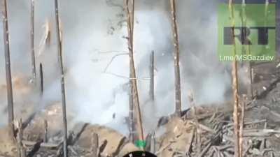 Ukrainian soldier lands what looks like an rpg shot from a trench at a russian T-72 damaging the main gun, apparently not disabling the cannon as it fires back at the trench. Location : Kreminna surrounding forests.