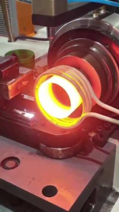 Induction coil heating up a metal tube