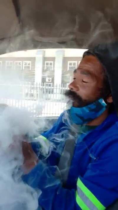 The Rasta that works with me. He smokes out of a glass bottle neck. As a novice smoker (can't take bog hits) he totally blew me away with the way he pulls. (Location: Cape Town SA)