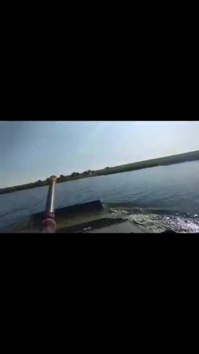 Ukrainian BMP catches fish while crossing a river