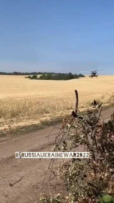 Ukrainian choppers fly by Ukrainian soldiers in the East