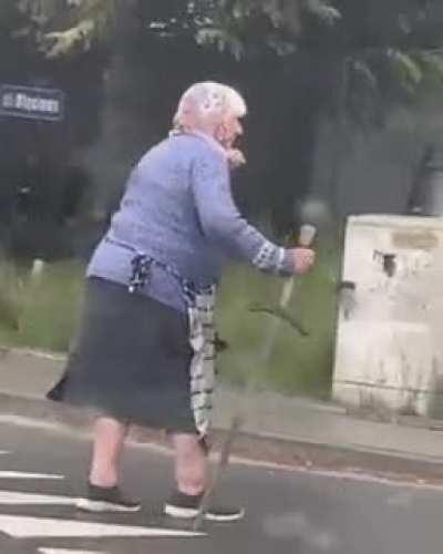 An old lady walking with a knight sword