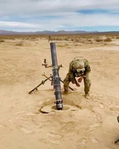 Slow motion video of a guy firing a military mortar