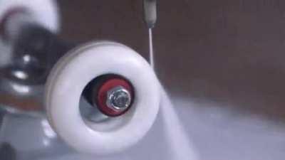 Spinning a skateboard wheel so fast that the heat and centripetal force rips it apart