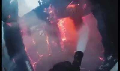 Gopro view of a firefighter putting out a house fire. Effective work. The bright red fire rapidly dying (with sound)