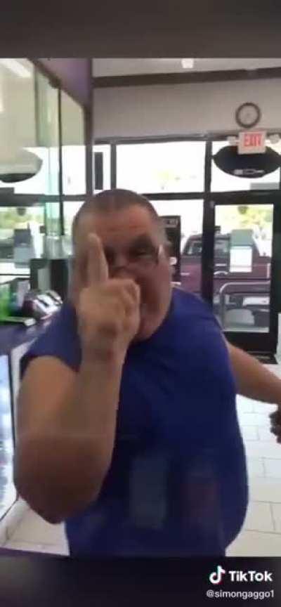 Man with no neck attempts to act tough to store employees.