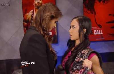 AJ Lee with a big gulp as Stephanie McMahon comes closer to her