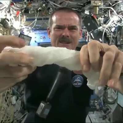 This is what happens when you wring out a wet towel while floating in space.