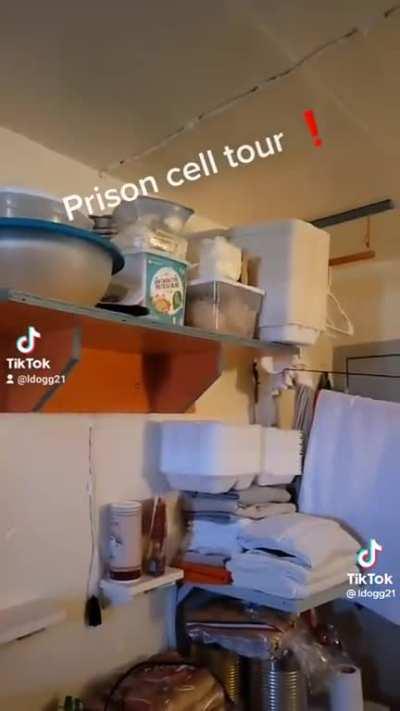 Prisoner shows off the inside of his cell