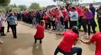 Woman pulls the wrong way in a tug-of-war match