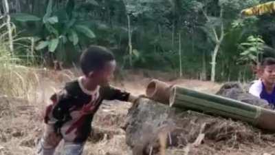 Kids Playing With Homemade Bamboo Cannon.