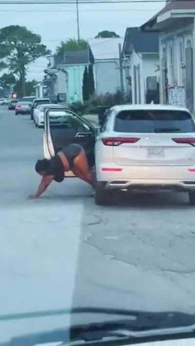 Lady blocks the street for twerk video.