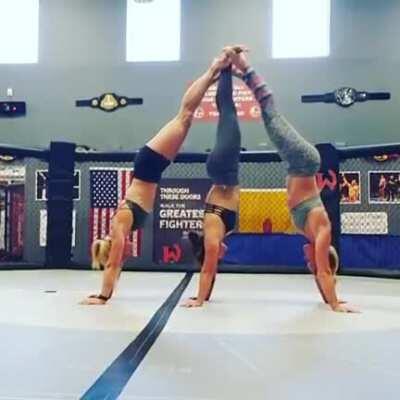 Jessie Graff, Holly Holm, and Michelle Waterson making a human pendulum