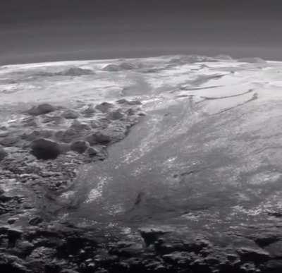 A wide shot of Pluto’s Mountains and Frozen Plains from the New Horizons Space Probe