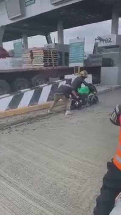 Idiot wanted to avoid paying the toll through a closed booth, gets stuck in fresh concrete instead.