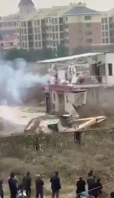 Chinese man fights off excavator that came to demolish his house with fireworks .