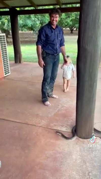 Little kid learning how to handle big snakes...