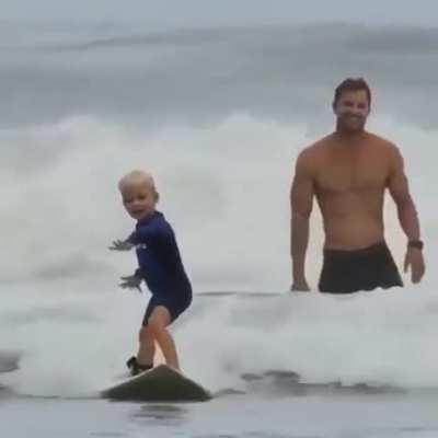 Fathers joy of his little surfer boy.